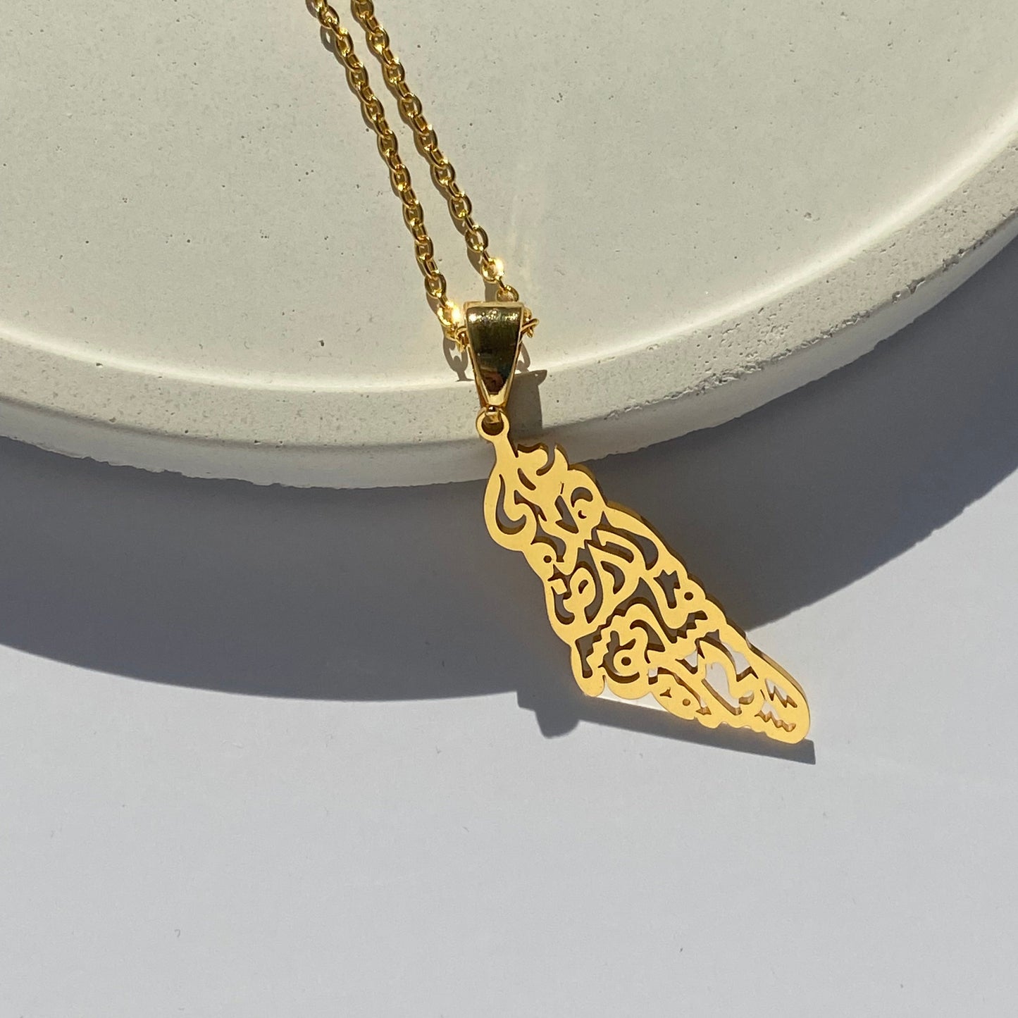 “على هذه الأرض ما يستحق الحياة” Palestine necklace in gold